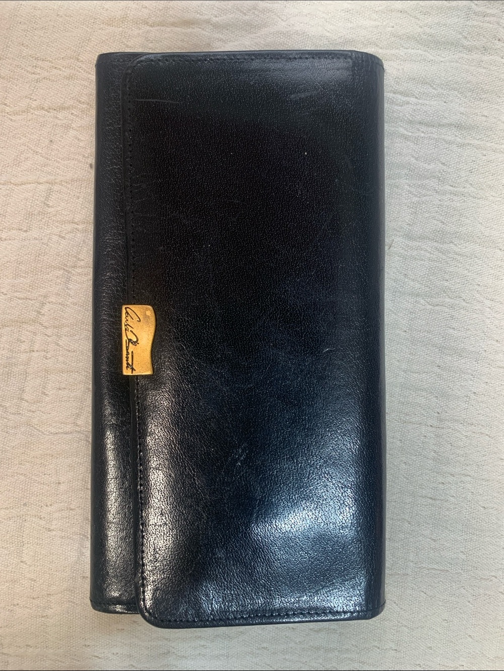 Vintage Carla Banti black leather clutch with signature gold tone plaque
